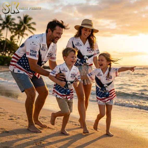 Family wearing matching bowling Hawaiian shirts with patriotic eagle, American flag, fireworks, and stars print in red, white, and blue, photographed on a beach during golden hour.