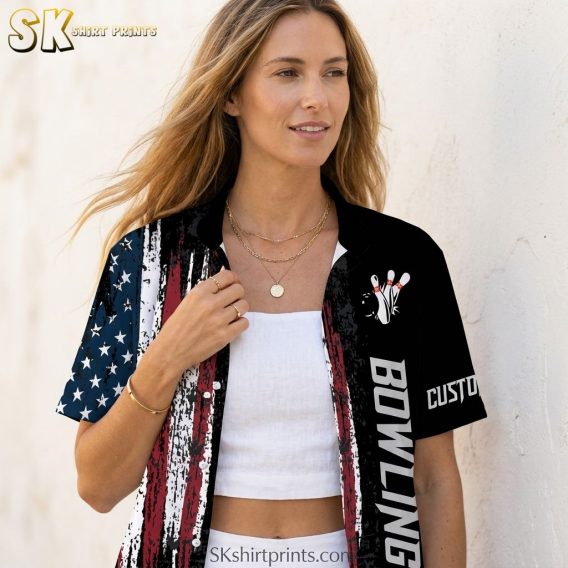 Woman wearing a custom Hawaiian bowling shirt in a closeup lifestyle shot, showing American flag grunge stripes, blue star panel, and vertical bowling graphic detail