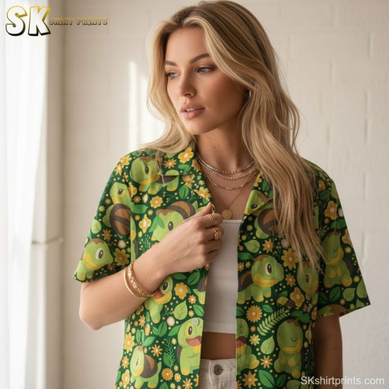 Green aloha shirt showing cartoon-style turtles and bees among tropical flowers and foliage