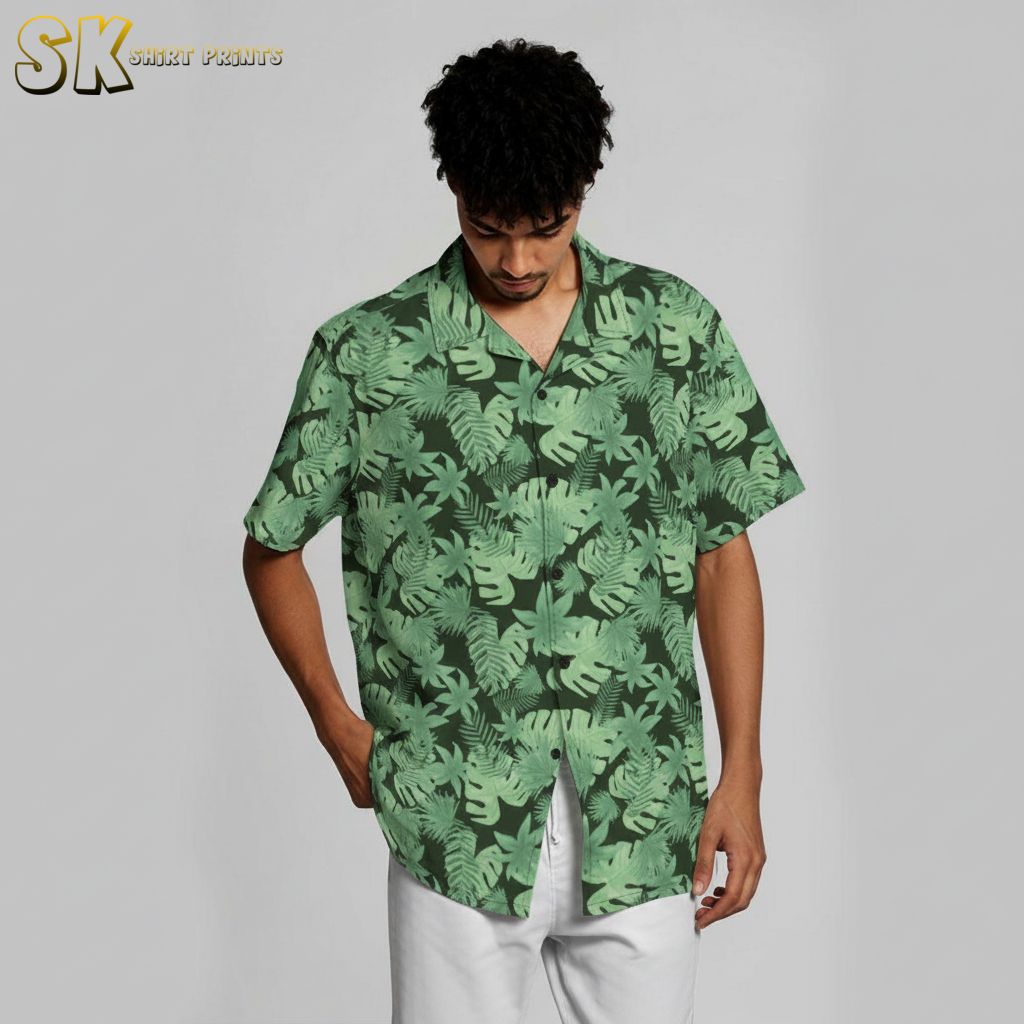 Green Hawaiian shirt with botanical leaf print showing multiple tropical leaf varieties