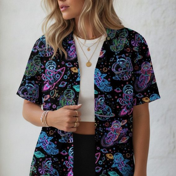 Aloha shirt with a Star Wars inspired space design showing raccoon astronauts, rockets, and planets printed in neon colors across the full fabric