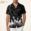 Male model wearing a Hawaiian bowling shirt with white lightning bolt print and bowling pin graphic on a black background, studio setting.