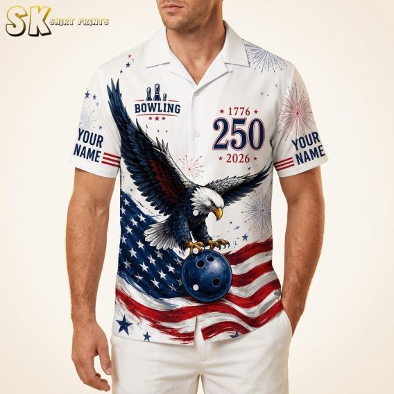 Men's Hawaiian bowling shirt with eagle holding a bowling ball, American flag design in red, white, and blue, stars and fireworks pattern, shown on male model against warm white background.