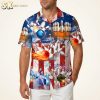 Hawaiian bowling shirt displayed on a male model in studio, showing bowling pins and balls pattern with red and blue American flag motif, stars, stripes, and flame accents