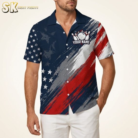 Male model wearing a Hawaiian bowling shirt with red, white, and blue stars and stripes pattern and bowling ball and pins design on a warm white studio background