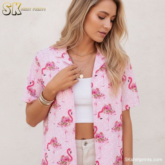 Hawaiian shirt with pink flamingos and tropical flowers arranged across light pink fabric