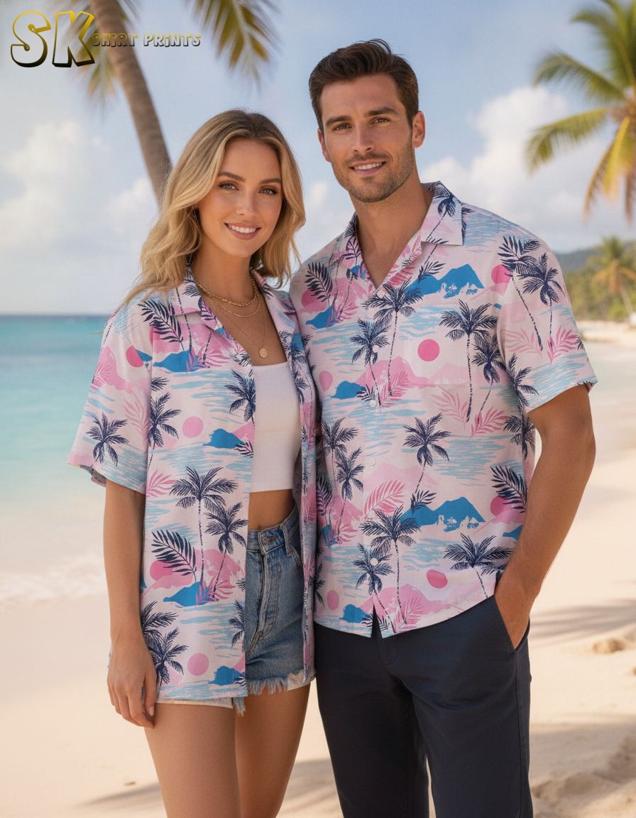 Men's pink Hawaiian shirt with tropical pattern showing pink sun circles, blue waves, and palm tree elements