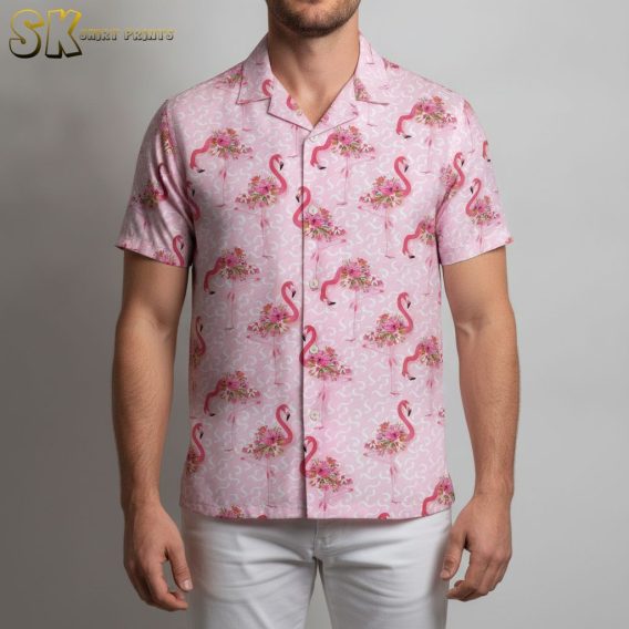 Men's pink tropical shirt displaying flamingo artwork and floral elements in tropical style