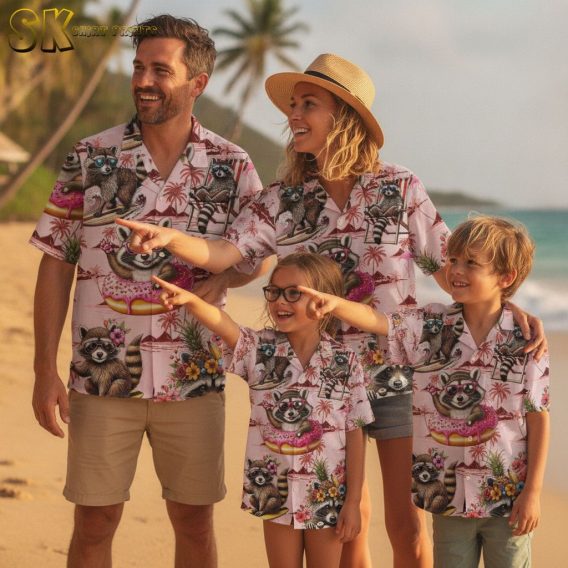 Pink and blue Hawaiian shirt with cartoon raccoons surfing and tropical flowers in beach scene