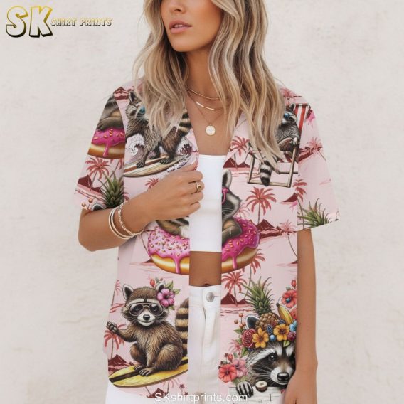 Pink and white Hawaiian shirt displaying cartoon raccoons with frosted donuts and sprinkles in beach setting