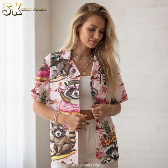 Pink and white Hawaiian shirt featuring raccoons on surfboards and in floaties with tropical flowers