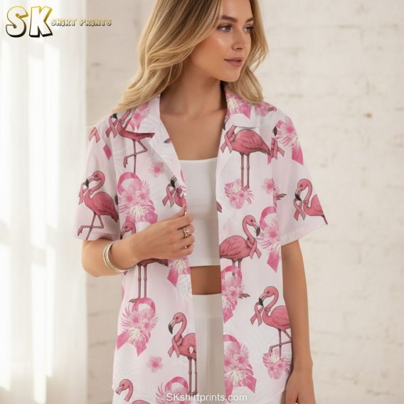 Pink and white Hawaiian shirt displaying flamingo motifs with tropical flowers and pink ribbon details