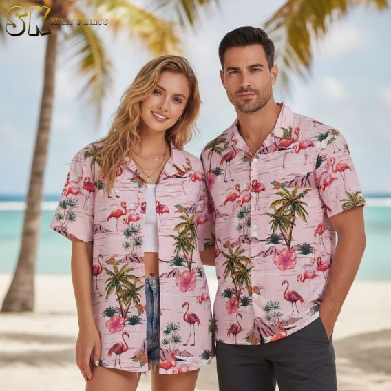 Pink flamingo hawaiian shirt with multiple flamingo graphics surrounded by palm trees and tropical plants