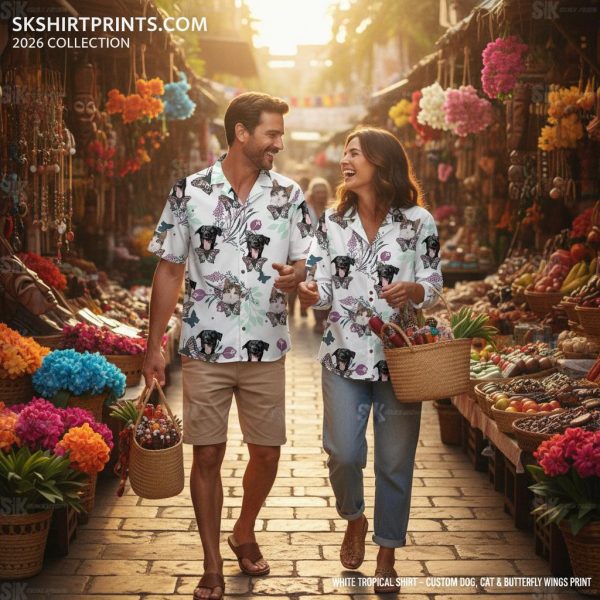 White tropical shirt with bold floral and bird print displayed on a sunny beach background