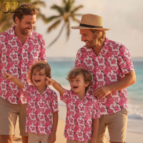 Womens pink Hawaiian shirt with pink hibiscus flowers, white accents, and dark green tropical leaves