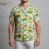 Yellow flower Hawaiian shirt displaying cartoon bananas in grass skirts holding drinks on leafy background