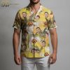 Yellow flower Hawaiian shirt displaying face portraits and palm tree motifs on light background