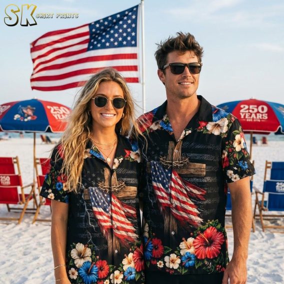 Couple wearing 250th anniversary Hawaiian shirts in all available colors, black base with American flag cross, hibiscus flowers in red white and blue, and lightning pattern