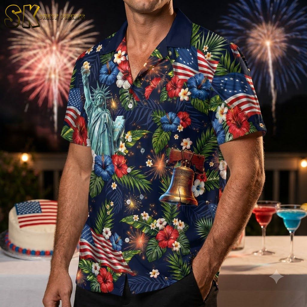 Man wearing an America 250 Hawaiian shirt with Statue of Liberty, bald eagle, American flag, and hibiscus flower print against a dynamic studio background