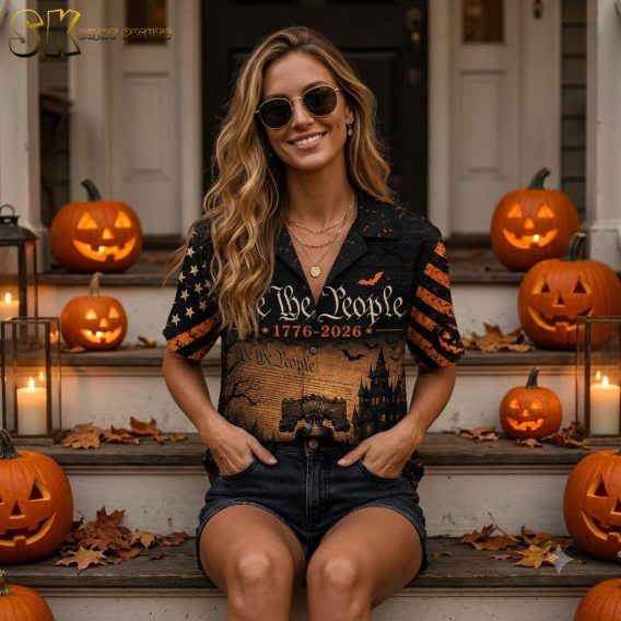 Female model wearing America 250th anniversary Hawaiian shirt with Halloween patriotic all-over print, including jack-o'-lanterns, ghosts, bats, Liberty Bell, and We the People 1776-2026 text in orange and black