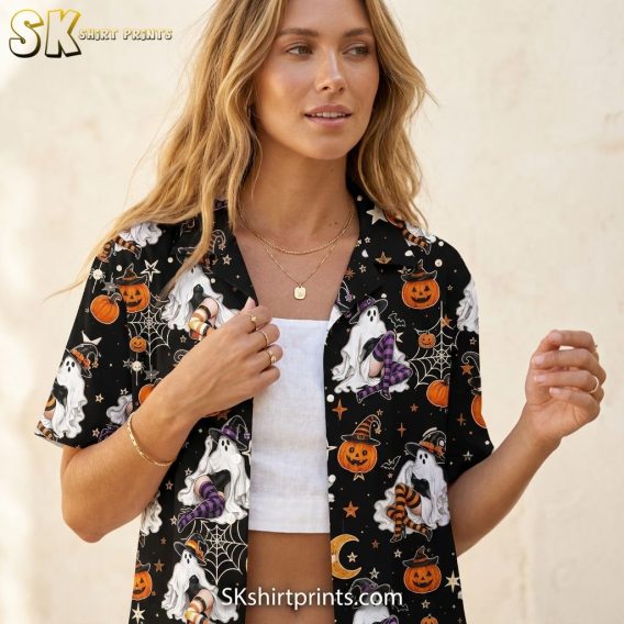 Close-up lifestyle photo of a woman wearing a Halloween costume Hawaiian shirt with ghost, jack-o-lantern, bat, and spiderweb print on a black background