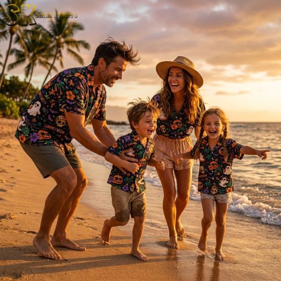 Family wearing Summerween Hawaiian shirts as Halloween costumes on a golden hour beach, shirts feature ghosts with sunglasses, jack-o'-lanterns, hibiscus flowers, palm trees, bats, and starfish all-over print