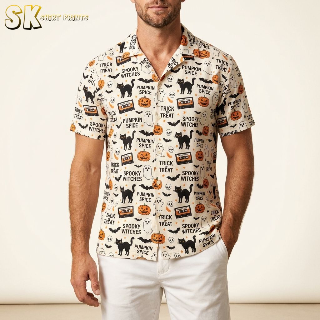 Man wearing a Halloween Hawaiian shirt with pumpkins, black cats, skulls, bats, and candy print on a white studio background