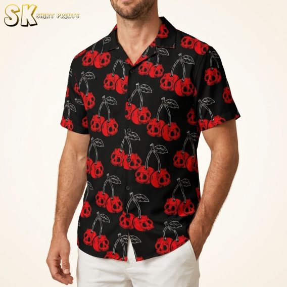Men's black Hawaiian shirt with red cherry skull pattern, studio photo on male model, warm white background