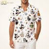 Mens Halloween Hawaiian shirt with cartoon duck witch, skeleton, and mummy characters printed across orange, black, and purple fabric, shown on a male model against a white background.