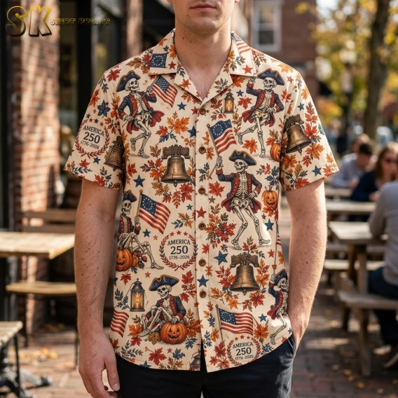 Man wearing a cream mens halloween hawaiian shirt with an all-over print of dancing colonial skeletons in tricorn hats, jack-o'-lanterns, and America 250 crests.