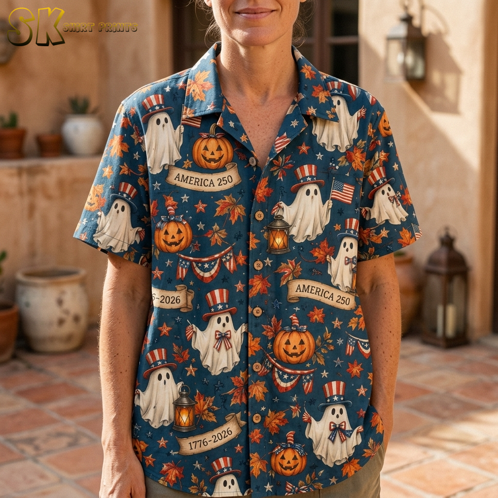 Close-up of a woman wearing a dark blue pumpkin hawaiian shirt, showing detailed cartoon ghosts in Uncle Sam hats, carved jack-o'-lanterns, autumn leaves, and patriotic bunting.