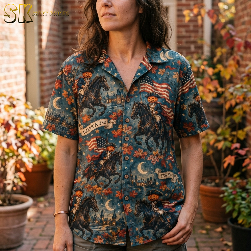 Close-up of a spooky hawaiian shirt worn by a woman, showing detailed pumpkin-headed colonial riders, crescent moons, stars, and autumn leaves in orange, brown, and blue.