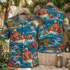 Christmas aloha shirt shown on hanger, front and back, with Santa fishing from a boat, leaping dolphins, hibiscus flowers, and wrapped gifts on a blue ocean print