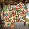 Christmas aloha shirt on hanger showing front and back, featuring a Santa playing ukulele, palm trees, hibiscus flowers, flamingos, candy canes, and Christmas ornaments in red and green