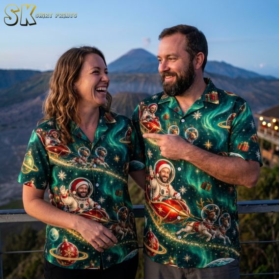 Couple wearing matching christmas aloha shirts with Santa astronaut and reindeer space print in dark green and red, short-sleeve button-up style