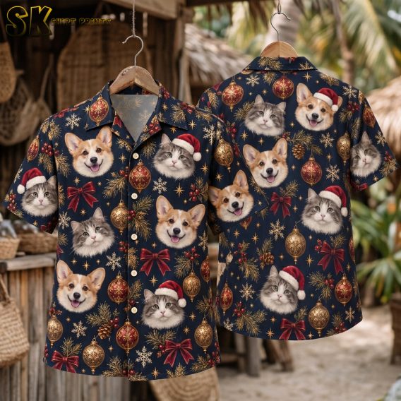 Christmas Hawaiian shirt mens style shown front and back on hanger, dark blue short-sleeve button-up with corgi and cat faces wearing Santa hats, gold ornaments, holly berries, and red bows