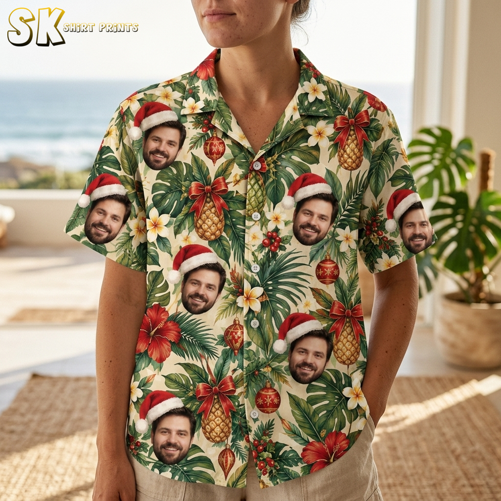 Closeup of a woman wearing a Christmas Hawaiian shirt womens style, showing Santa hat face motif, hibiscus flowers, pineapples, and red ornaments on beige