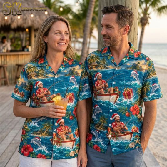 Couple wearing matching christmas hawaiian shirts for men and women featuring Santa fishing, dolphins, and festive tropical prints