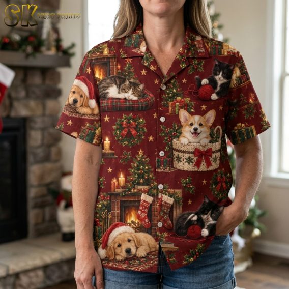 Closeup of a woman wearing a christmas vacation hawaiian shirt with detailed corgi, kitten, and golden retriever puppy print in red, green, and gold
