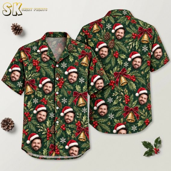 Flat lay of a cotton Christmas Hawaiian shirt showing front and back with a dark green Santa hat face, holly, bells, and snowflake all-over print