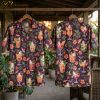 Front and back hanger view of a dark purple halloween hawaiian shirt with an all-over pattern of cocktail glasses holding white ghost figures, hibiscus flowers, bats, and crescent moons.