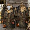 Halloween Hawaiian shirt shown front and back on hanger, featuring dancing skeletons, glowing jack-o'-lanterns, bats, and twisted trees on a dark background