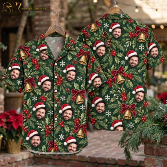 Front and back hanger view of a dark green Hawaiian shirt for Christmas featuring a repeating pattern of Santa hat faces, bells, snowflakes, holly, and pinecones
