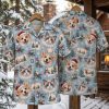 Hawaiian style Christmas shirt on hanger showing front and back, light blue background with corgi dogs in Santa hats, cats, Christmas trees, holly, bells, and snowflakes