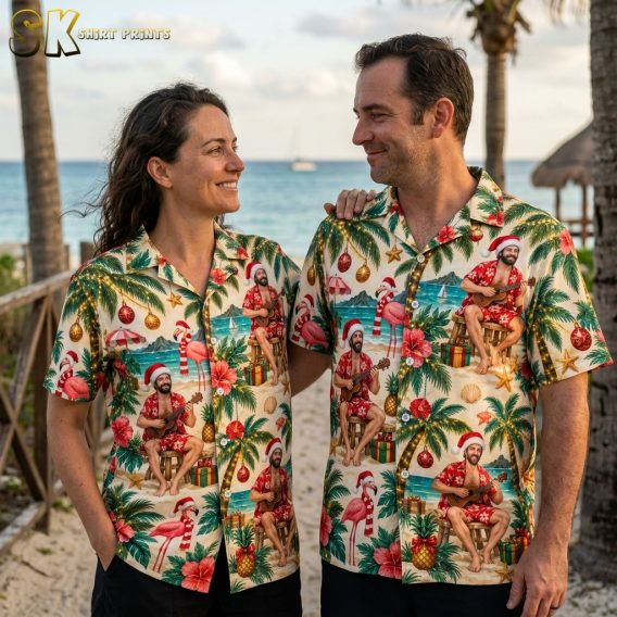 Couple wearing matching Hawaiian style Christmas shirts with Santa ukulele, flamingos, palm trees, and holiday ornament print in red and green
