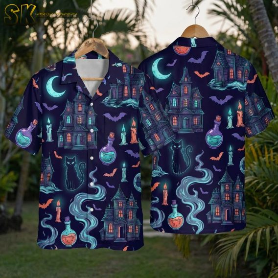Horror Hawaiian shirt on hanger showing front and back, dark navy blue fabric printed with haunted houses, black cats, bats, crescent moons, potion bottles, and candles in neon green, orange, purple, and teal