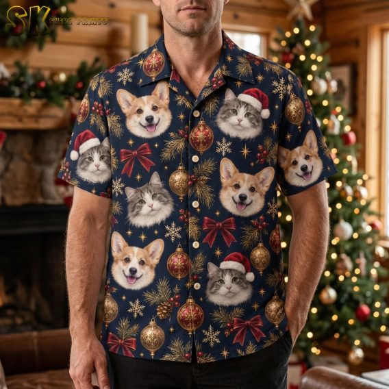 Man wearing a mens Christmas Hawaiian shirt with corgi and cat Santa hat print on dark blue fabric, short-sleeve button-up in a lifestyle setting