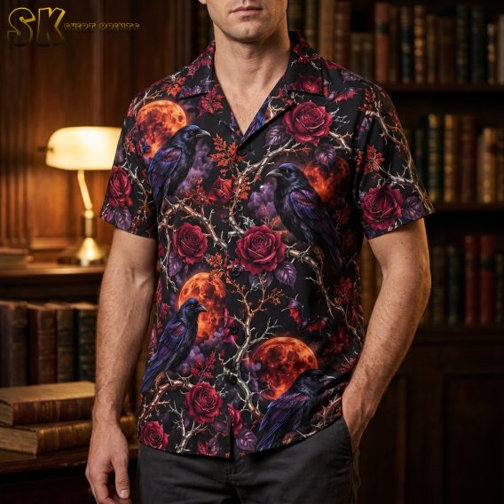 Male lifestyle photo of a man wearing a black short-sleeve button-up shirt with crows, red roses, orange moons, and bats in an all-over pattern.