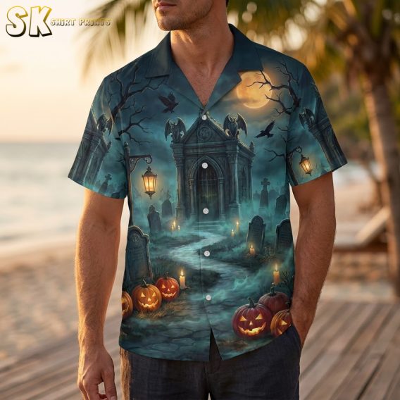 Man wearing a mens Halloween Hawaiian shirt with dark blue haunted graveyard print featuring pumpkins, bats, and a gothic mausoleum
