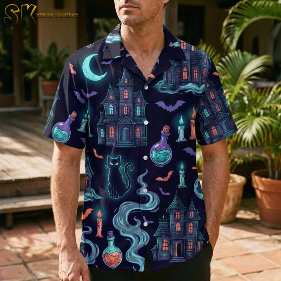 Man wearing a mens Halloween Hawaiian shirt with navy blue fabric printed with haunted houses, bats, black cats, potion bottles, and neon Halloween accents